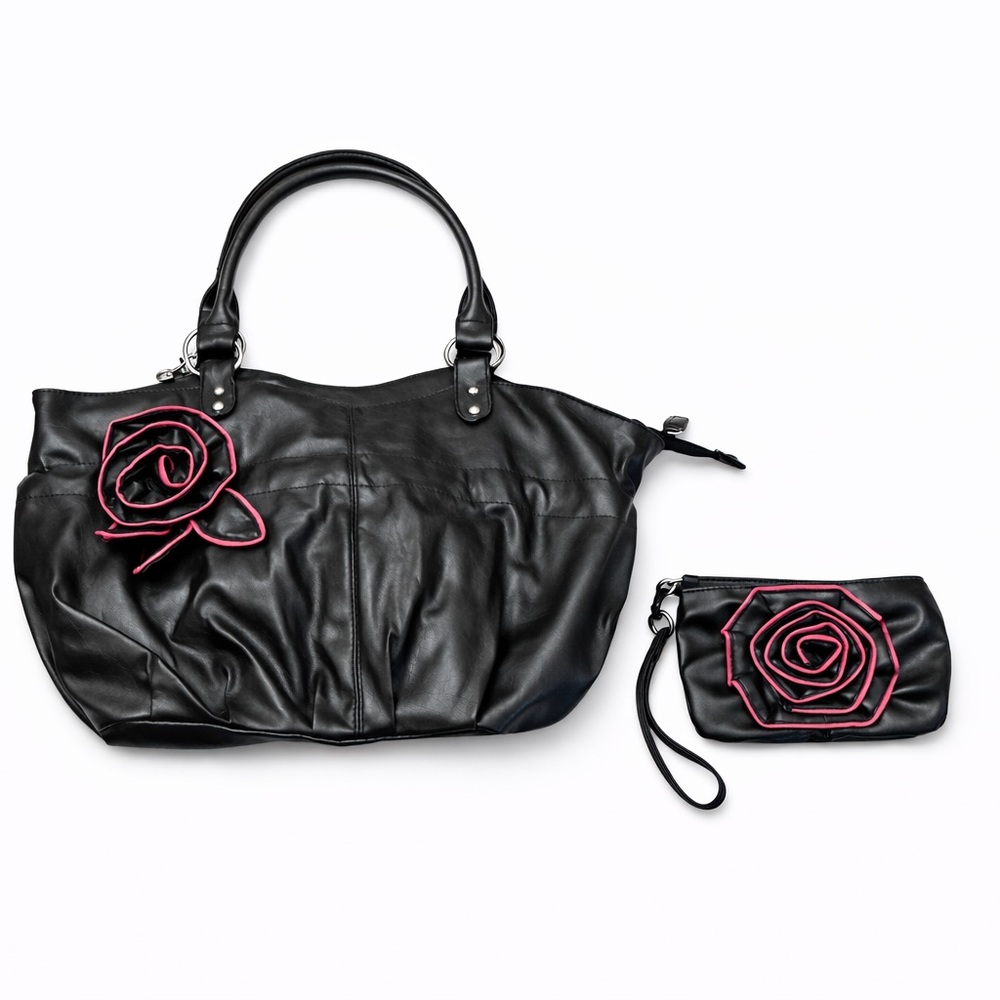 Stylish black faux leather handbag with matching wristlet, feat rosette accents